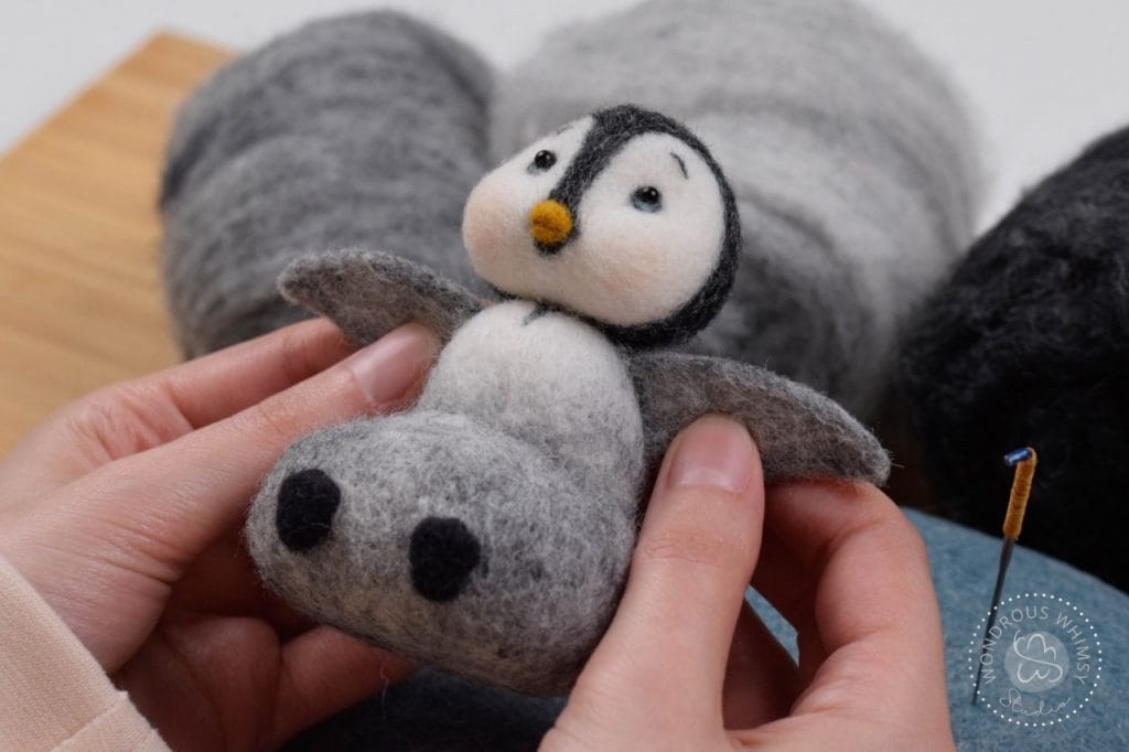 Needle felted sitting penguin feeling happy